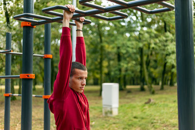 Sport man stretching at the park autumn, doing man do stretching exercises at autumn park. 