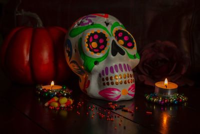 Close-up of illuminated candles on table