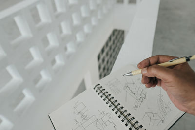 High angle view of hand holding a pencil at home