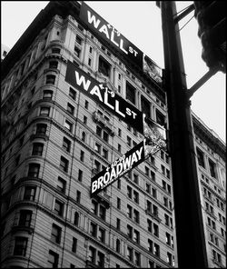 Low angle view of signboard against building