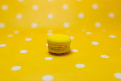 Close-up of coffee cup against yellow background