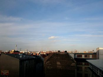 Buildings against cloudy sky