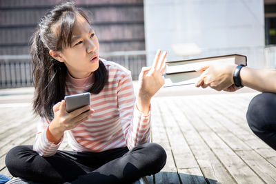 Full length of woman using mobile phone