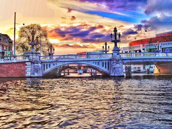 Bridge over river at sunset