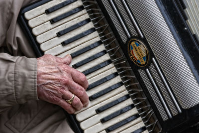 High angle view of hand holding piano