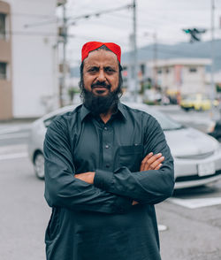 Portrait of man standing in city