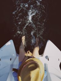 Directly above shot of girl sitting on boat in sea