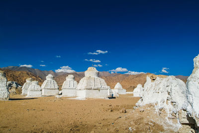 Scenic view of desert against blue sky