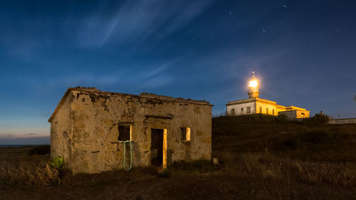 Old ruin building against sky at night