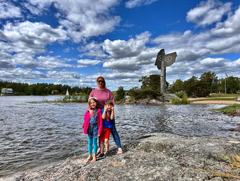 Rear view of woman standing at beach