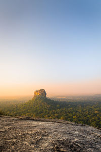 Scenic view of landscape against clear sky during sunset