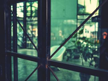 Close-up of glass window against building