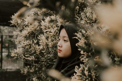 Portrait of young woman looking away