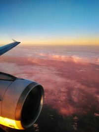 Cropped image of airplane at sunset