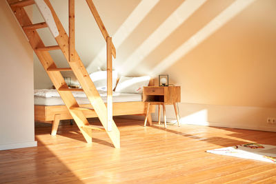 Rear view of woman sitting on hardwood floor