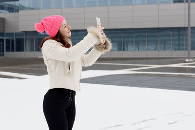 Full length of woman standing in snow