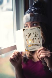 Close-up portrait of woman holding text