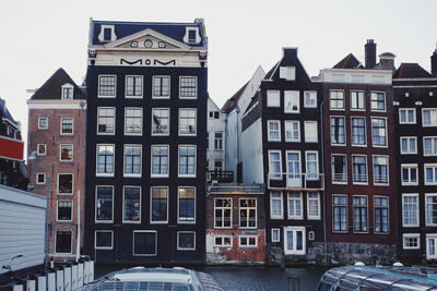 Buildings in city against sky during winter