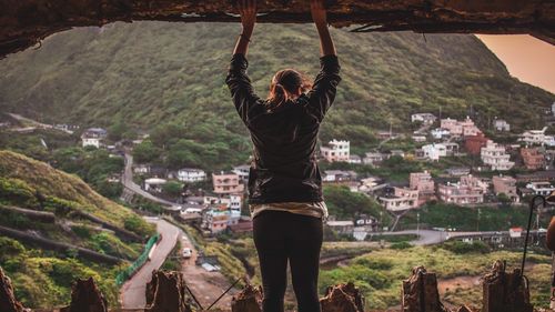 Rear view of woman looking at cityscape