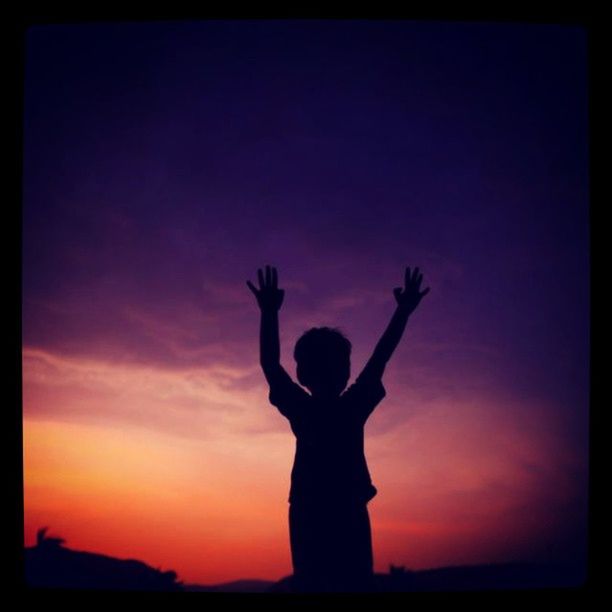 silhouette, sunset, transfer print, lifestyles, sky, leisure activity, standing, auto post production filter, orange color, arms raised, three quarter length, beauty in nature, nature, scenics, outdoors, tranquility, full length, childhood