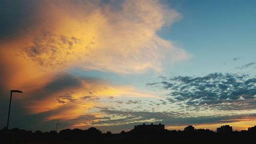 Low angle view of silhouette street against sky at sunset