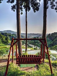 Trees on landscape against sky