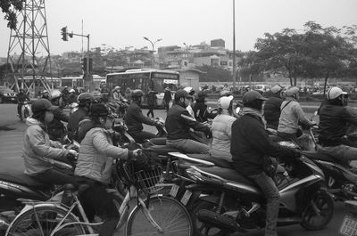 People on street in city against sky