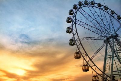 Low angle view of ferris wheel against sky