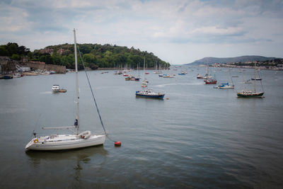 High angle view of sailboats moored on sea against sky