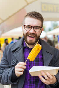 Portrait of smiling man holding ice cream