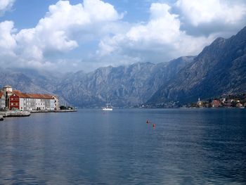 Scenic view of sea and mountains against sky