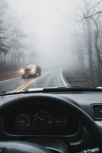 Car on road seen through windshield