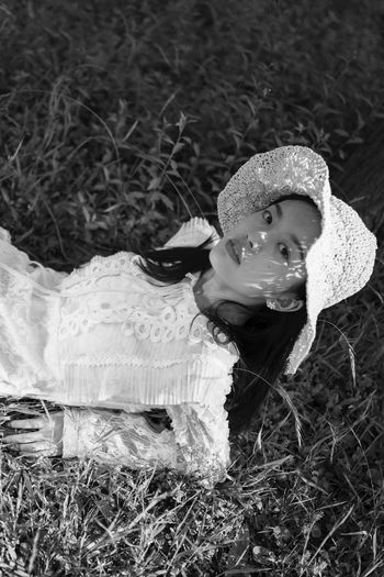 HIGH ANGLE VIEW PORTRAIT OF CUTE GIRL IN FIELD