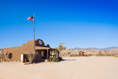 Built structure on beach against blue sky