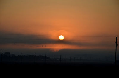 Silhouette landscape against sky during sunset