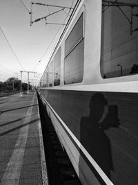 Shadow of train on railroad station platform