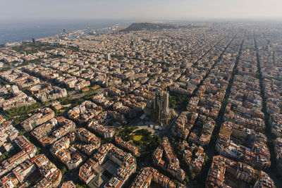 Spain, catalonia, barcelona, helicopter view of sagrada familia basilica and surrounding cityscape