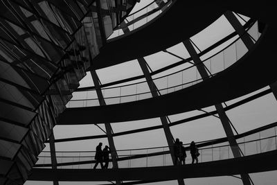 Low angle view of silhouette people in modern building