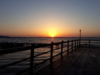 Scenic view of sea against clear sky during sunset