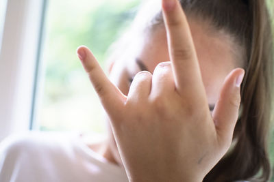 Close-up of woman hand on window