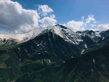 Panoramic view of snowcapped mountains against sky