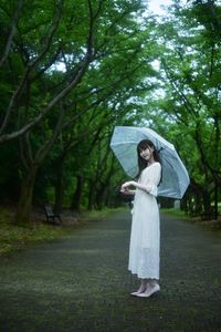 Full length of woman standing in rain