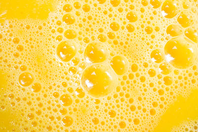 Full frame shot of beaten egg yolks with bubbles