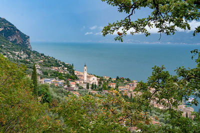 High angle view of townscape by sea against sky