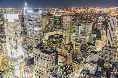 High angle view of illuminated buildings in city at night