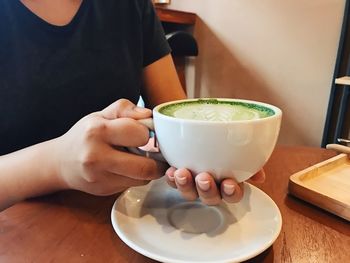 Midsection of woman holding drink