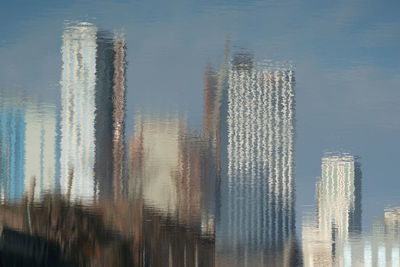 Reflection of buildings on river in city