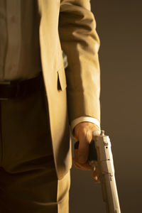 Midsection of man standing against black background