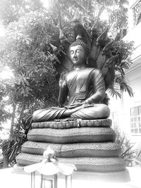 Low angle view of statue against trees