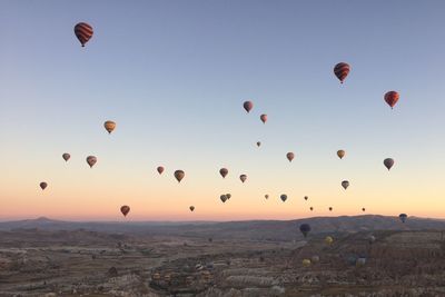 Hot air balloons flying in sky during sunrise